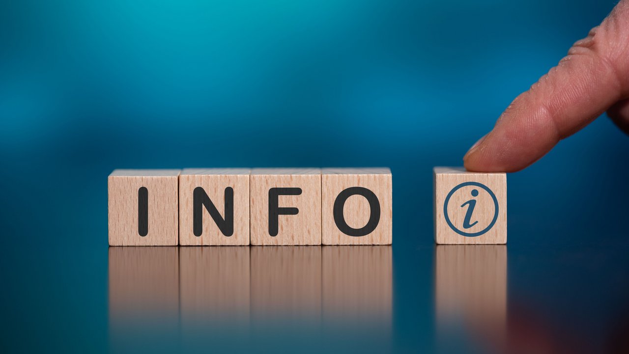 Das bild zeigt 5 Holzwürfel auf türkisfarbenem Hintergrund mit der Aufschrift INFO i