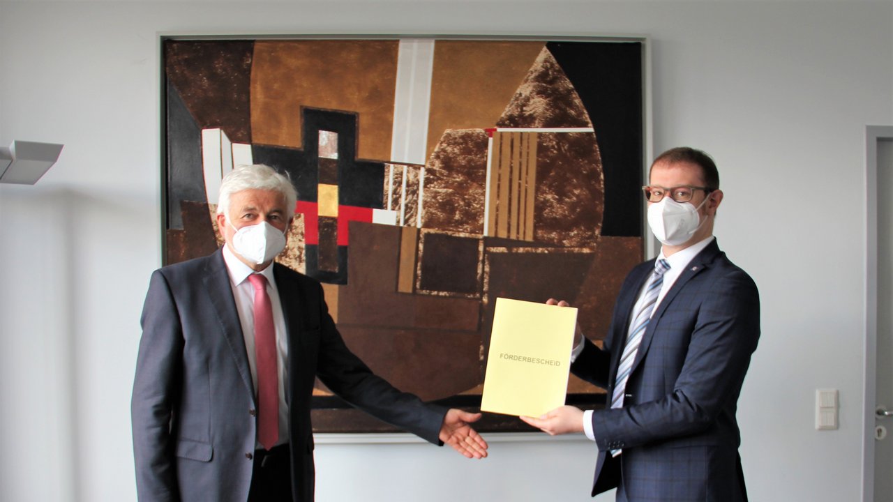 (v.l.n.r.): Übergabe Förderbescheid (Regierungspräsident Wolfgang Reimer und Bürgermeister Maximilian Friedrich); Quelle: Regierungspräsidium Stuttgart