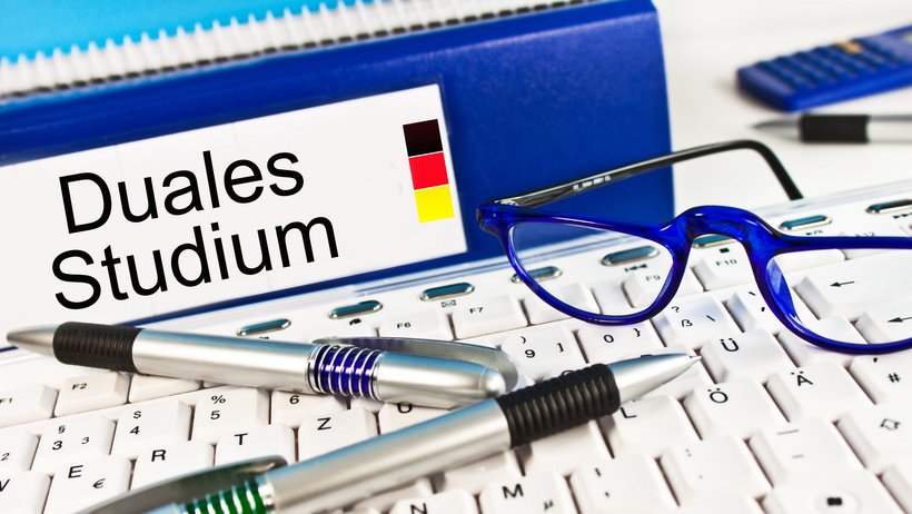 Bild zeigt Tastatur, Ordner und Kugelschreiben