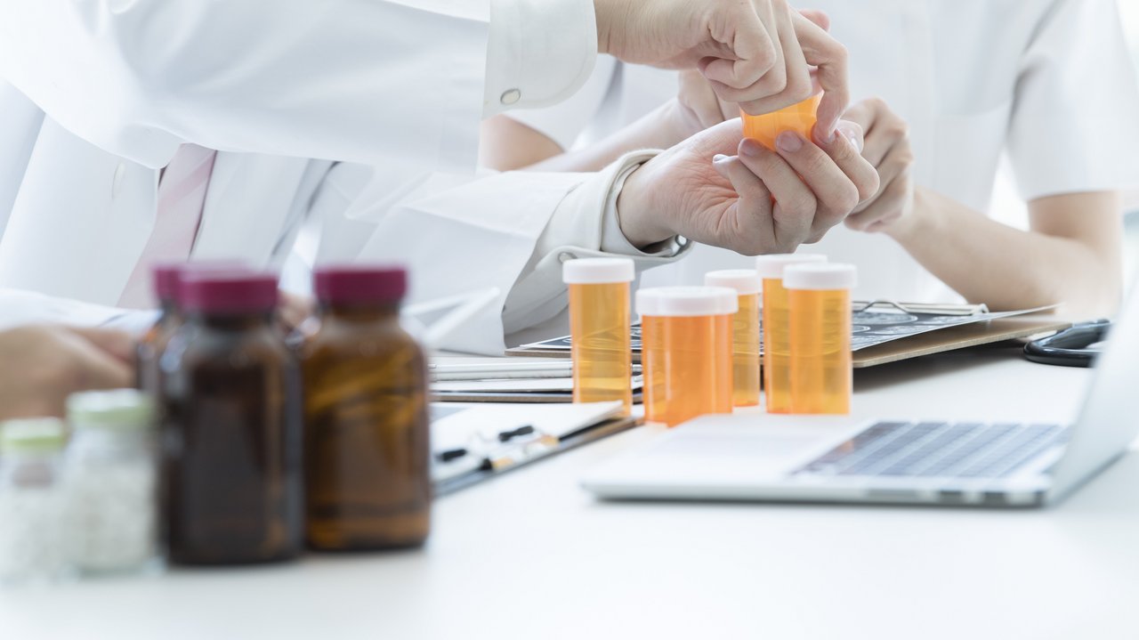 Ärzte bei Betrachten von Arzneidosen